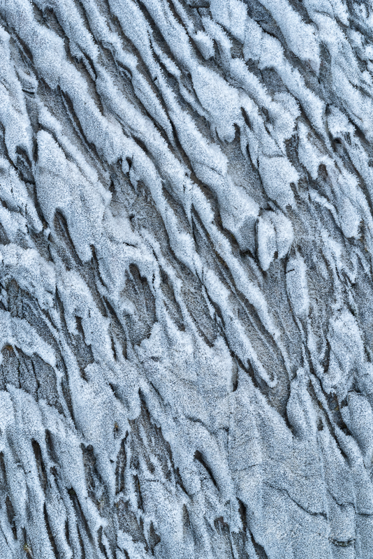 A gorgeous layer of dense frost causing patterns on the rock.